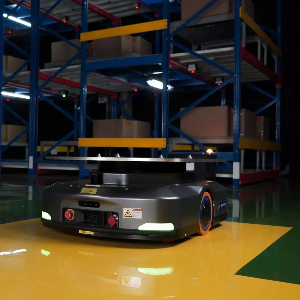 Asai Metal autonomous mobile robot on a warehouse floor between storage racks